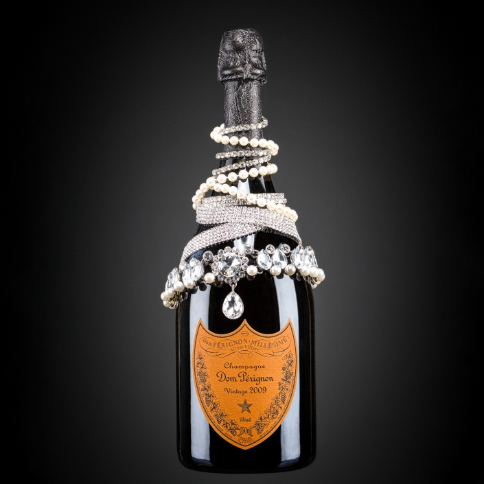 Bottle of Champagne with jewellery around it's stem